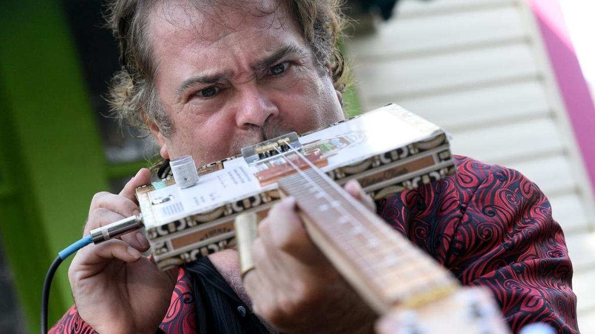 Steve Arvey will play his cigar box guitar Friday and Saturday during the Village of the Arts’ Bradenton Cigar Box Guitar Festival.