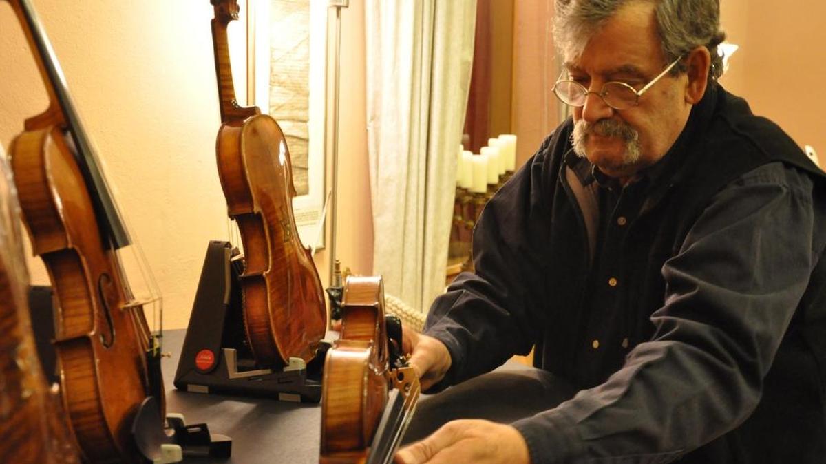 Amnon Weinstein with some of the violins in his collection.
