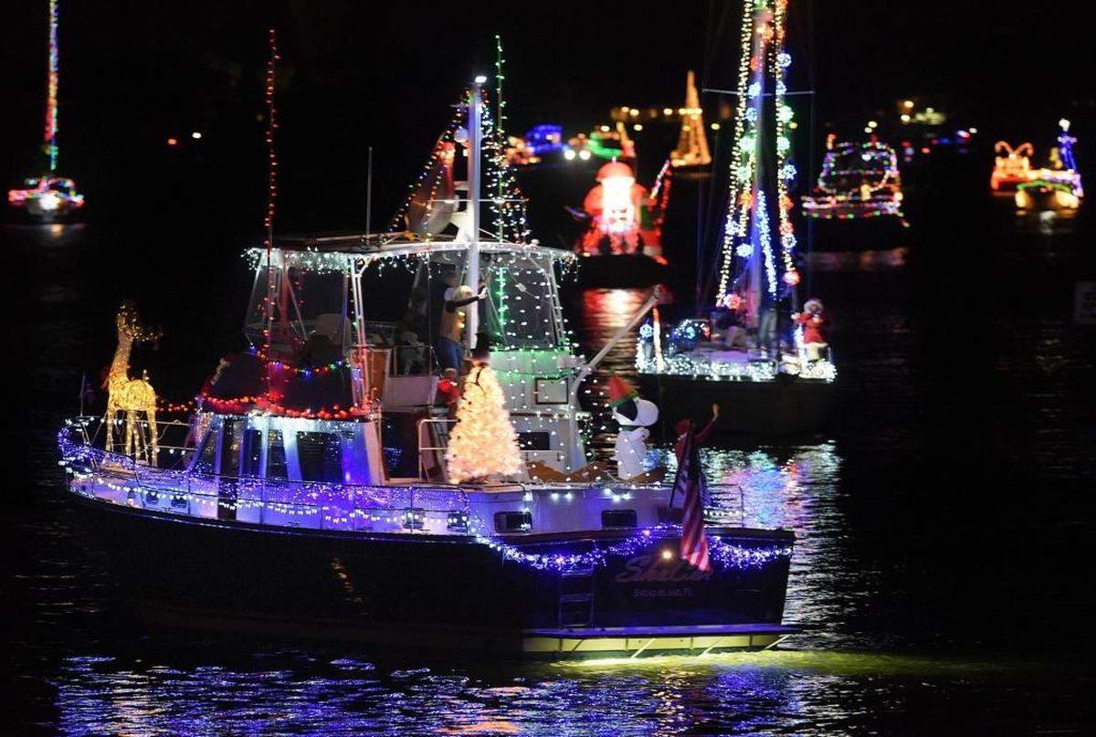 Boats glide between downtown Bradenton and Palmetto during a past Manatee River Holiday Boat Parade. 