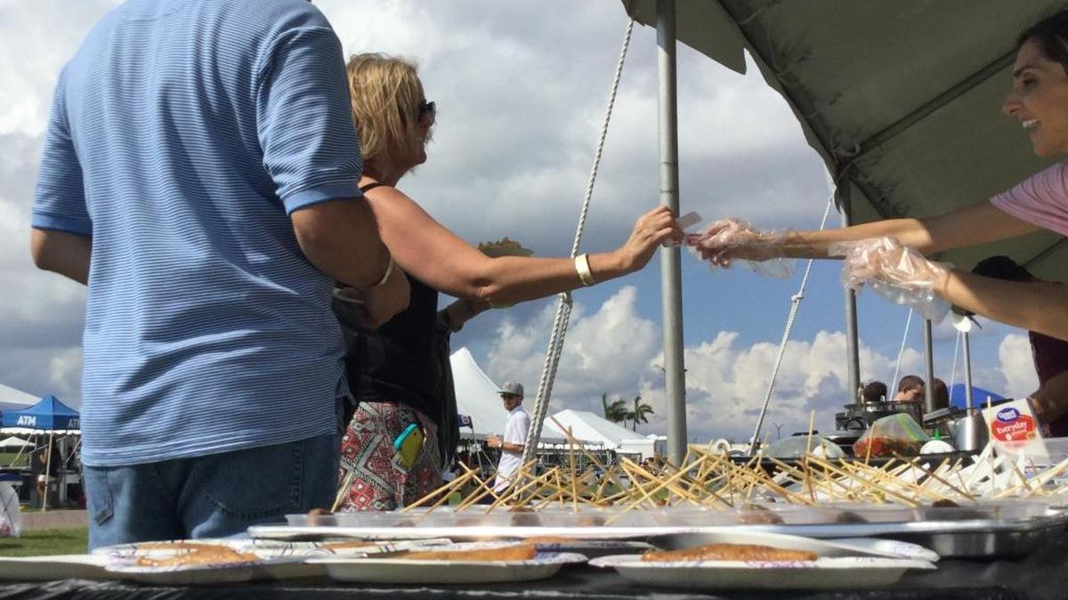 Festival-goers sample bacon delights at last year’s Beer, Boats and Bacon Festival.