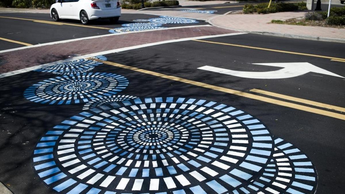 Decorative circles are seen painted onto the sidewalk on Wednesday afternoon at the corner of 12th Street West and Ninth Avenue West in downtown Bradenton. The new road-applied art is the second installation of public art along Old Main Street geared to drawing pedestrians down Old Main Street and into the eclectic Village of the Arts.