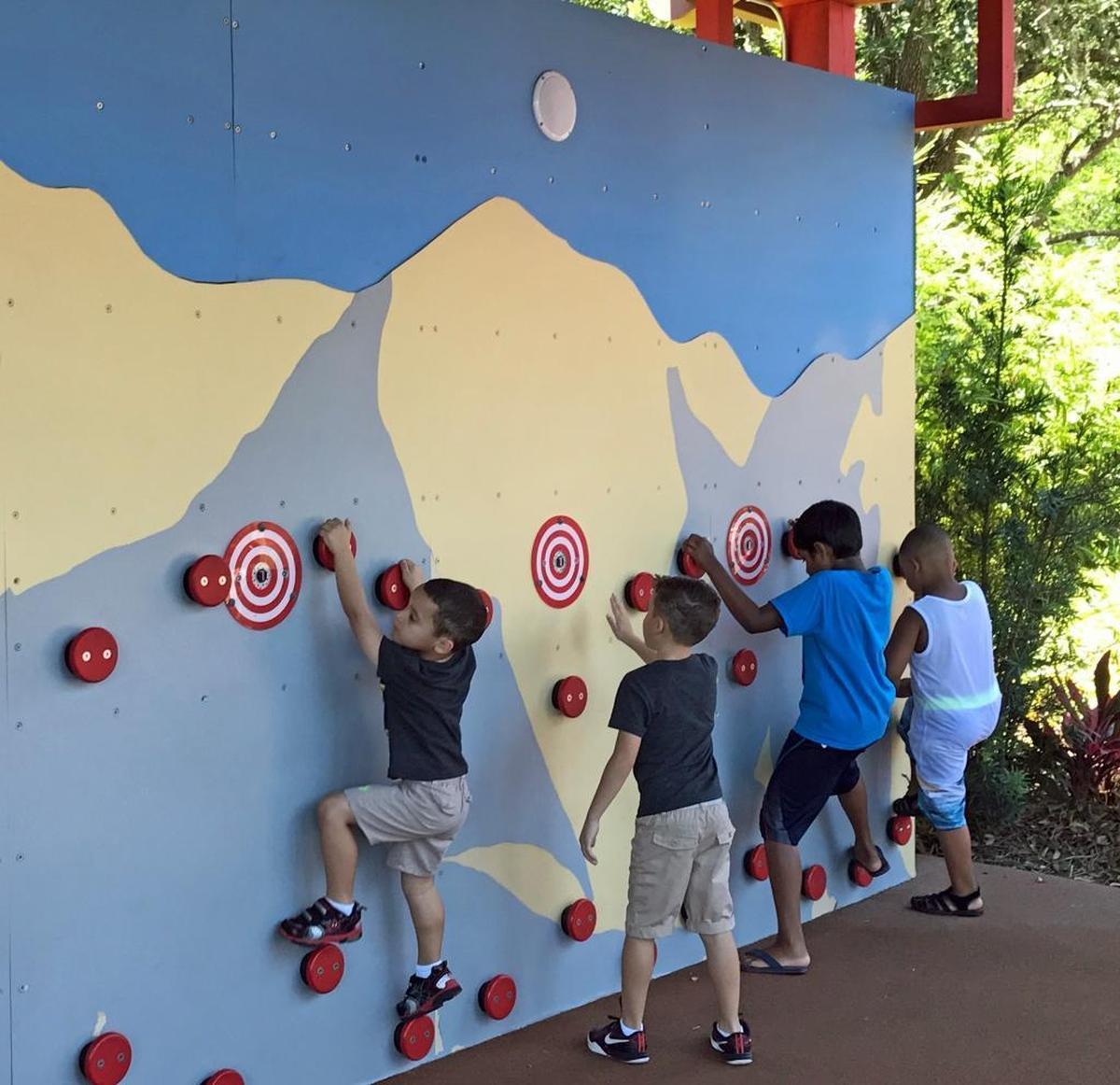 Kids practice ninja warrior skills like rock-climbing near the entrance to the Ninjago ride at Legoland.