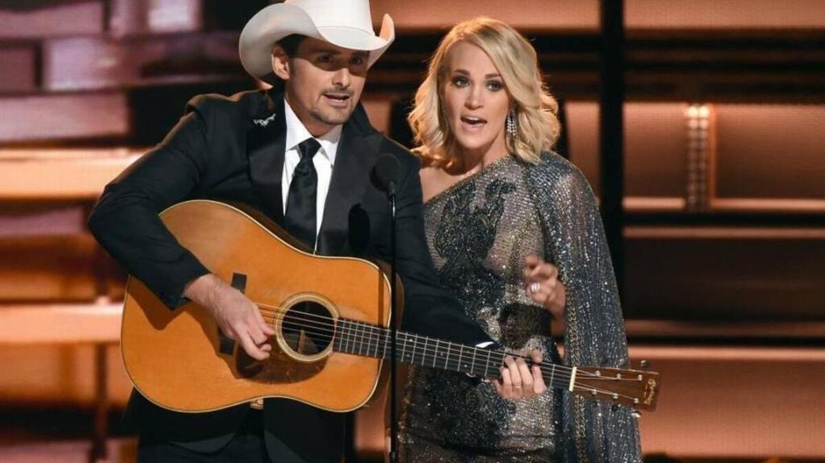 Hosts Brad Paisley, left, and Carrie Underwood speak at the 50th annual CMA Awards at the Bridgestone Arena on Nov. 1 in Nashville, Tennessee.