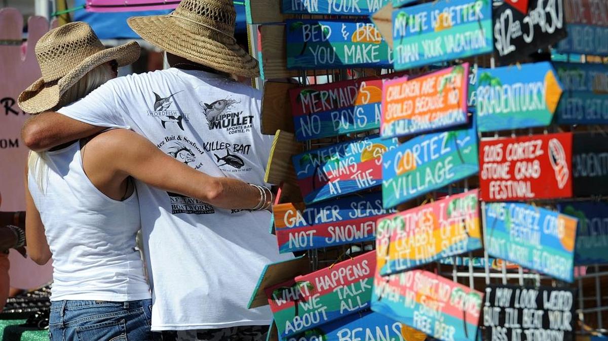 A couple enjoys each other’s company at a past Cortez Stone Crab Festival in Cortez Village.
