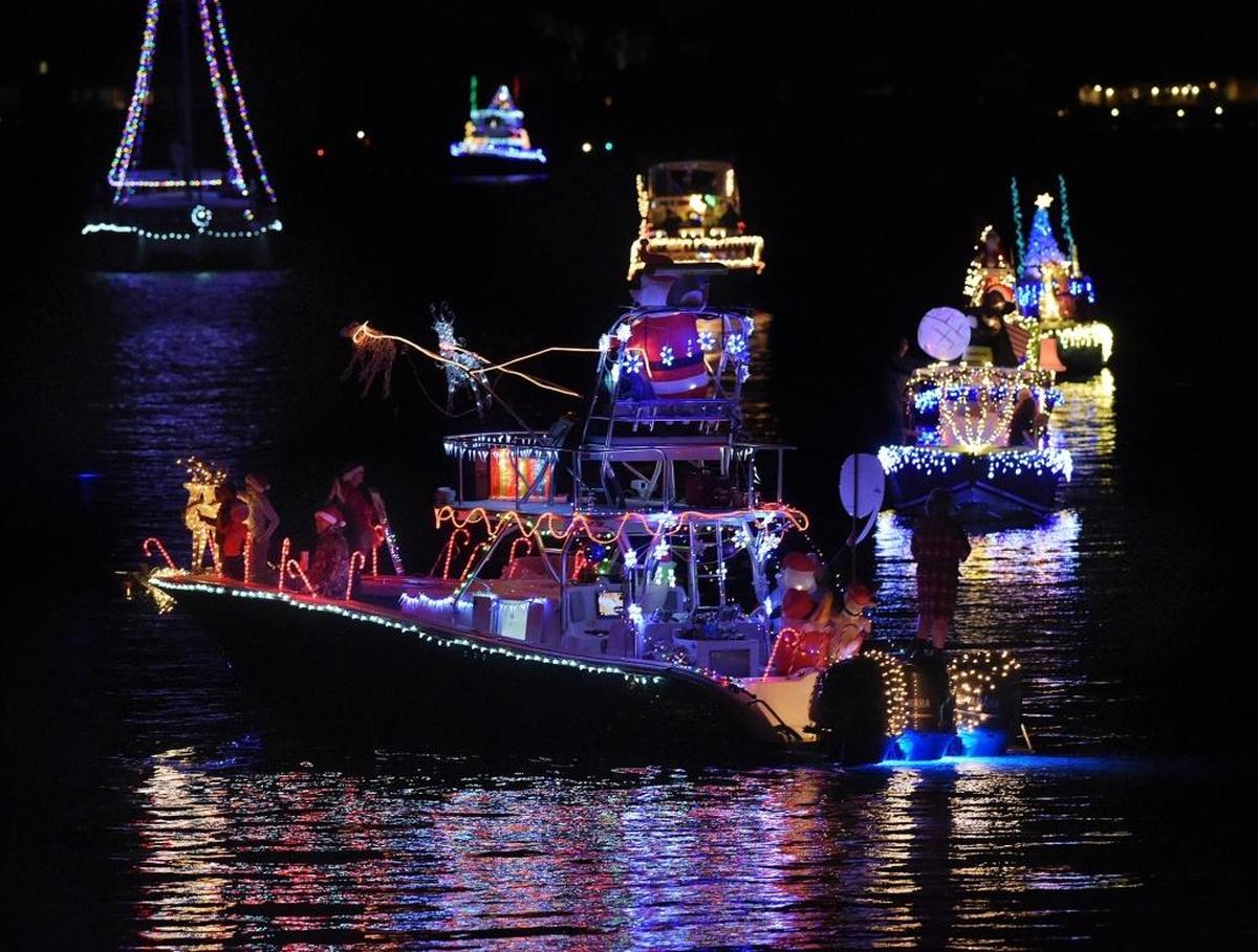 Boats glide between downtown Bradenton and Palmetto during a past Manatee River Holiday Boat Parade. 