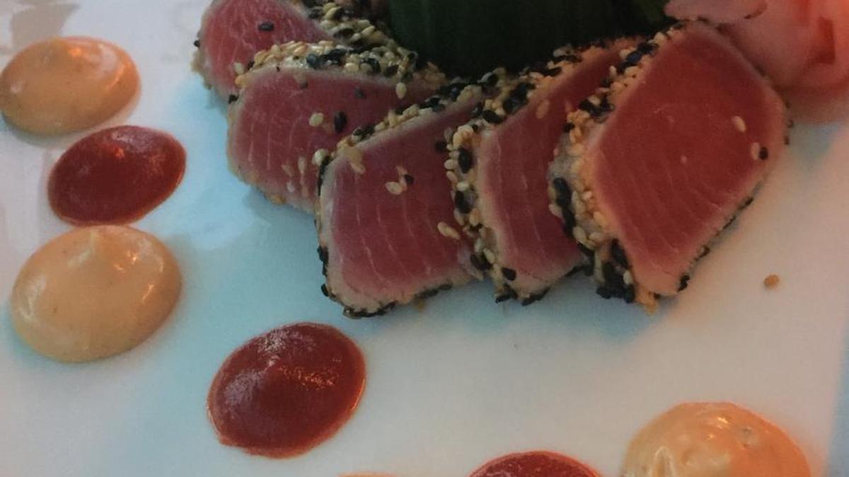 The ahi tuna appetizer at Island Time Bar & Grill on Bradenton Beach is crusted with sesame seeds and served with seaweed salad and Thai chili sauce.