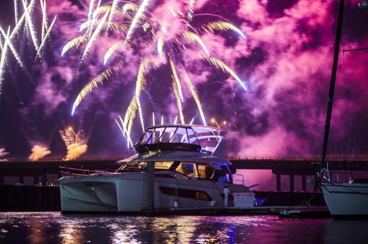 Fireworks explode in the distance behind a boat floating in Twin Dolphin Marina after the third annual Bradenton Area River Regatta on the Manatee River in Bradenton.