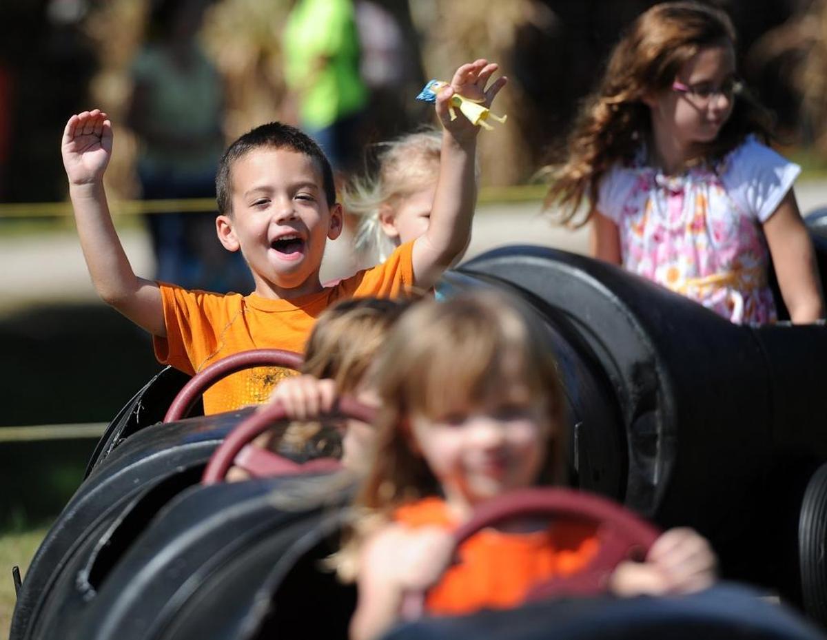Children enjoy a train ride at the Hunsader Farms Pumpkin Festival.