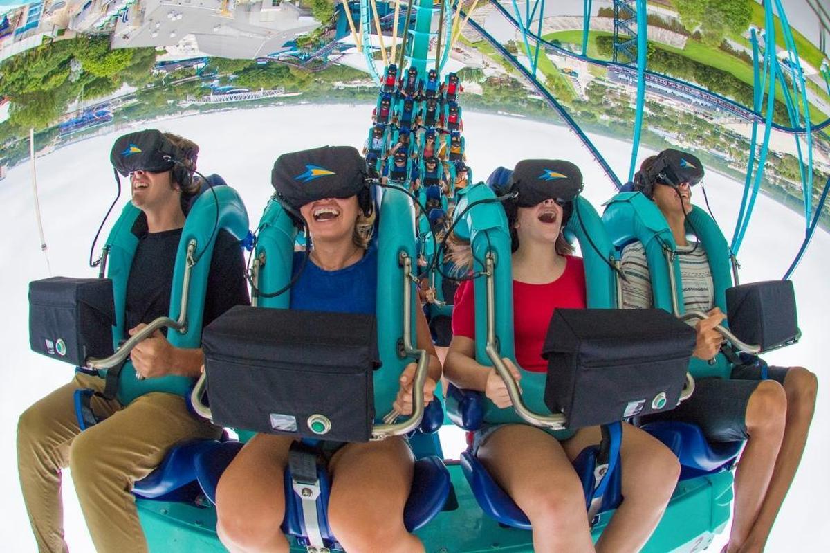 As Kraken speeds through a loop and turns upside down, its riders wearing virtual reality headsets are experiencing an undersea adventure.