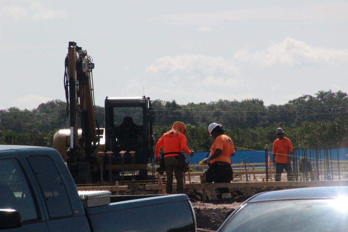 The work site of a new Parrish elementary school was muddy on Thursday, but workers pushed ahead with campus construction.