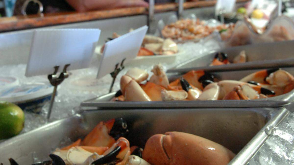 Customers order a pound of stone crab claws at the Star Fish Company Seafood Market and Restaurant in Cortez in this file photograph. Fishermen are gearing up for the start of the 2015 stone crab season that starts Thursday. 
 File Photo- GRANT JEFFERIES/Bradenton Herald