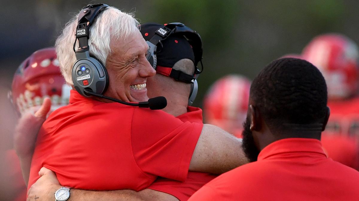 Coach Paul Maechtle hugs another coach after an early touchdown during Friday night’s game between Southeast High at Cardinal Mooney in Sarasota.