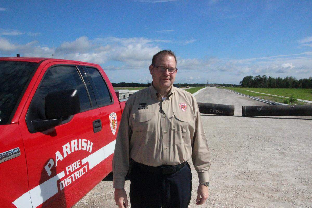 Michael Williamson, division chief of the Parrish Fire District, stands at the entrance to North River Ranch, which will bring more than 5,000 homes to the Parrish area.