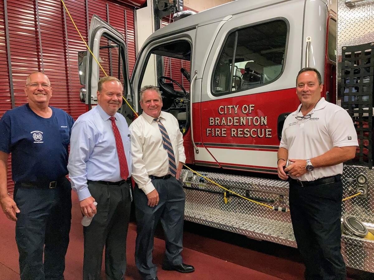 Bradenton officials gave City Administrator Rob Perry an unofficial welcome after Wednesday’s public meeting. He joined Mayor Gene Brown to tour several facilities, including city hall, public works and a fire station. Perry (second from right) poses in front of a fire truck with Battalion Chief Steve Trompke (left), Brown (second from left) and Fire Chief Chuck Edwards (right).