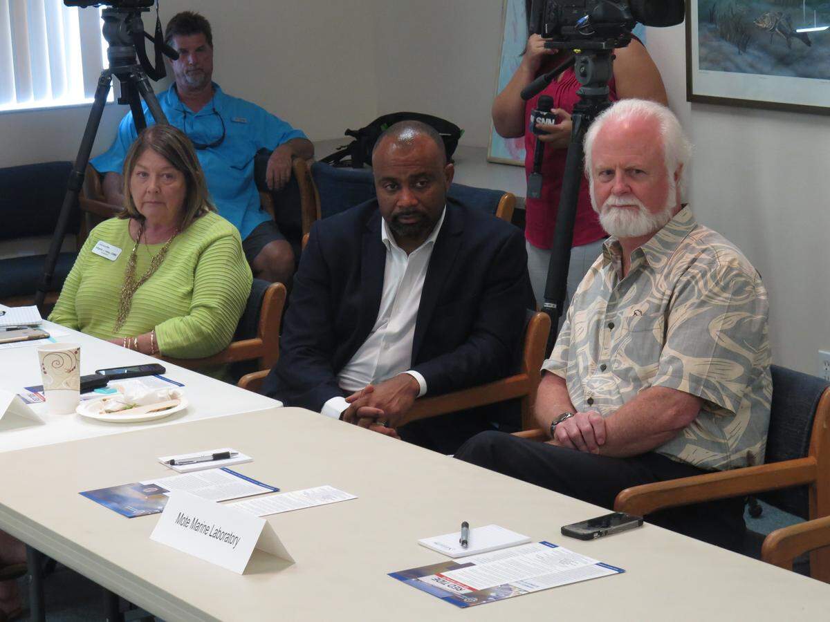 Department of Economic Opportunity Executive Director Ken Lawson, who was then the CEO of Visit Florida, participates in a red tide meeting in August 2018 at Mote Marine Laboratory & Aquarium at Mote’s facility in Sarasota. At left is Visit Sarasota President Virginia Haley, and at right is Mote Marine President Dr. Michael Crosby.