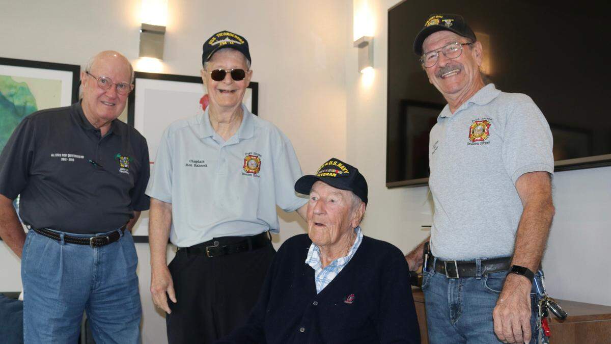 Among members of Braden River VFW Post 12055 who came March 15, 2022, to help Warren Pizzello celebrate his 100th birthday were (standing, from left) Denny King, Ron Babcock and Graham Ellis. Pizzello is a Bradenton resident and World War II Navy veteran.