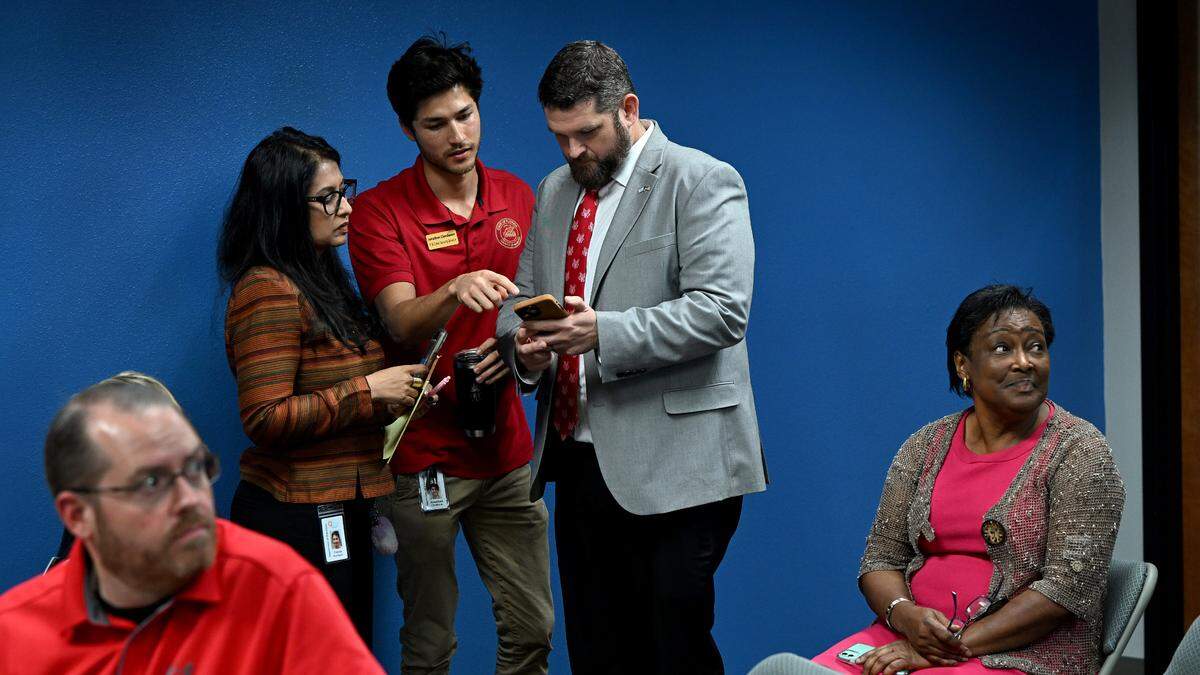 Vinola Rodrigues, Jonathan Clendenon and Supervisor of Elections James Satcher watch results come in on Nov. 5, 2024.