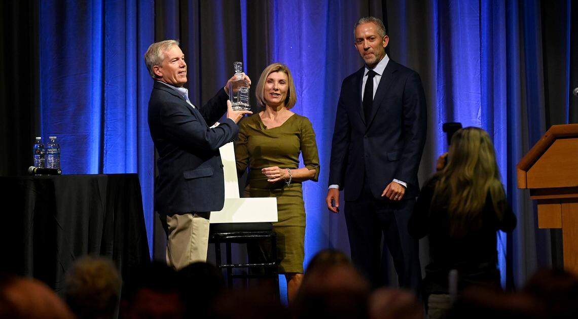 Outgoing chair David Sessions accepts a gift from Sharon Hillstrom and incoming chair for the EDC, Benjamin Hanan at the annual update for the Bradenton Area Economic Development Corporation luncheon at the Bradenton Area Convention Center in Palmetto, October 28, 2022.
