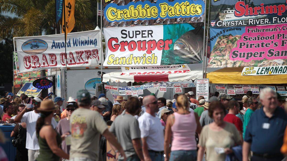 PAUL VIDELA/Bradenton Herald 
 Banners advertise the seafood fare at the 2012 Cortez Commercial Fishing Festival. For those not inclined to eat fish, there are also land-based alternatives available at the festival, up to and including corn dogs and barbecue.