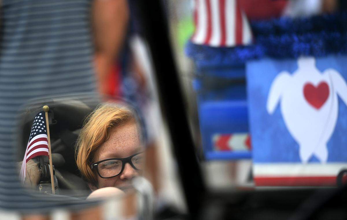 11/11/21—A young person on the Turtle Watch float is seen in a side mirror in the City of Anna Maria’s Old Soldiers and Sailors Veterans Day Parade.