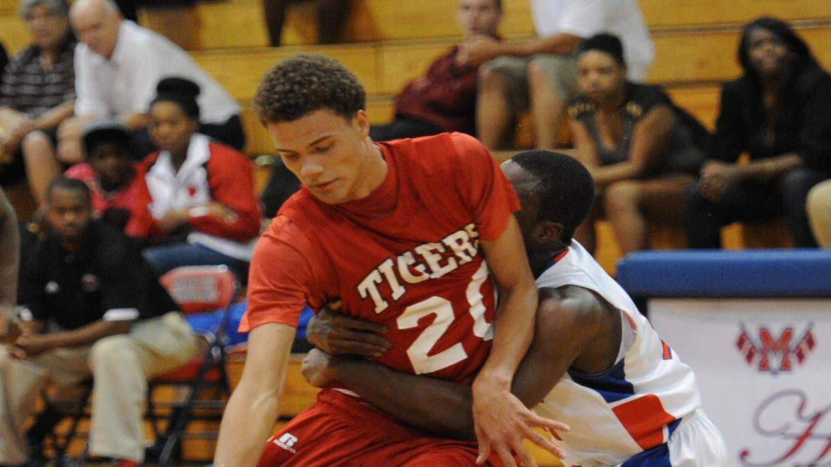 Palmetto's Jarrid Rhodes, left, draws a foul during a Nov. 19, 2013, game against Manatee in Bradenton.HERALD FILE PHOTO