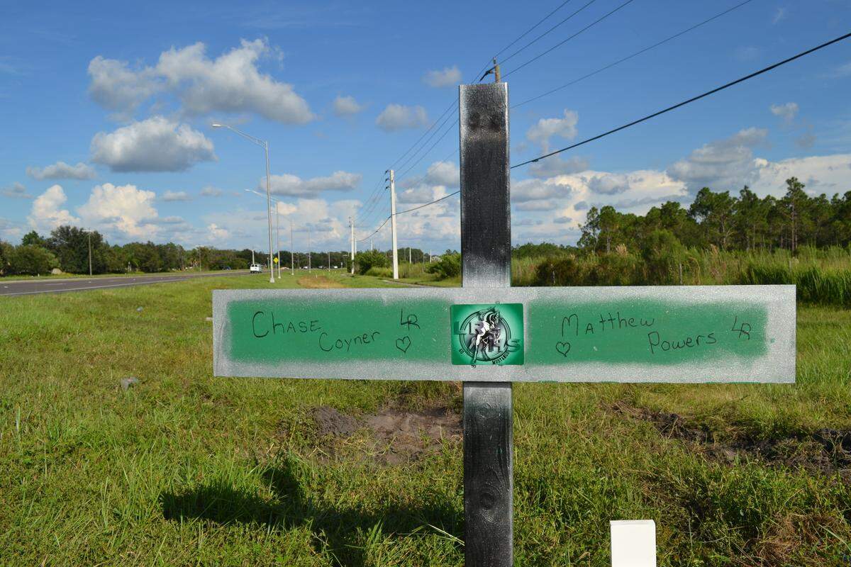 A cross painted in Lakewood Ranch High School colors bears the name of Chase Coyner and Matthew Powers. The boys were killed in a car crash at State Road 64 and Pope Road on Saturday night.