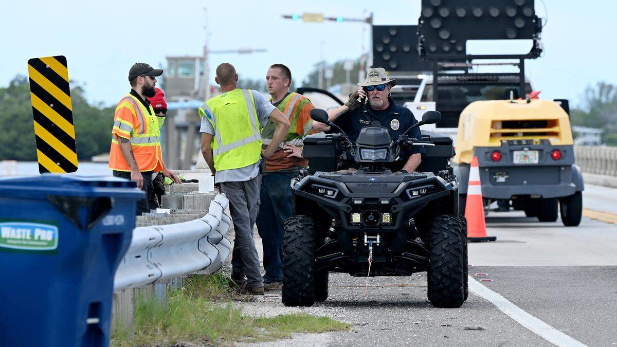Holmes Beach Police Chief William Tokajer sits on an ATV as workers address a hole that opened in the eastbound lane of the Manatee Avenue Bridge. The eastbound lanes were closed Wednesday afternoon as emergency repairs are needed to fix a hole in the bridge, according to the Florida Department of Transportation.