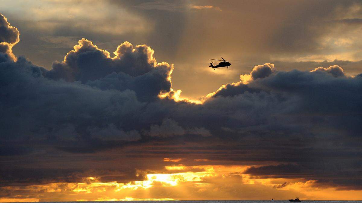 A military helicopter flies over the waters of Agana Bay in Hagatna, Guam, on Aug. 10, 2015. Residents can expect to see more military aircraft in the skies above the U.S. territory as base realignment in the Pacific shifts more Marines to Guam from Okinawa. (Tiffany Tompkins-Condie/McClatchy DC/TNS)