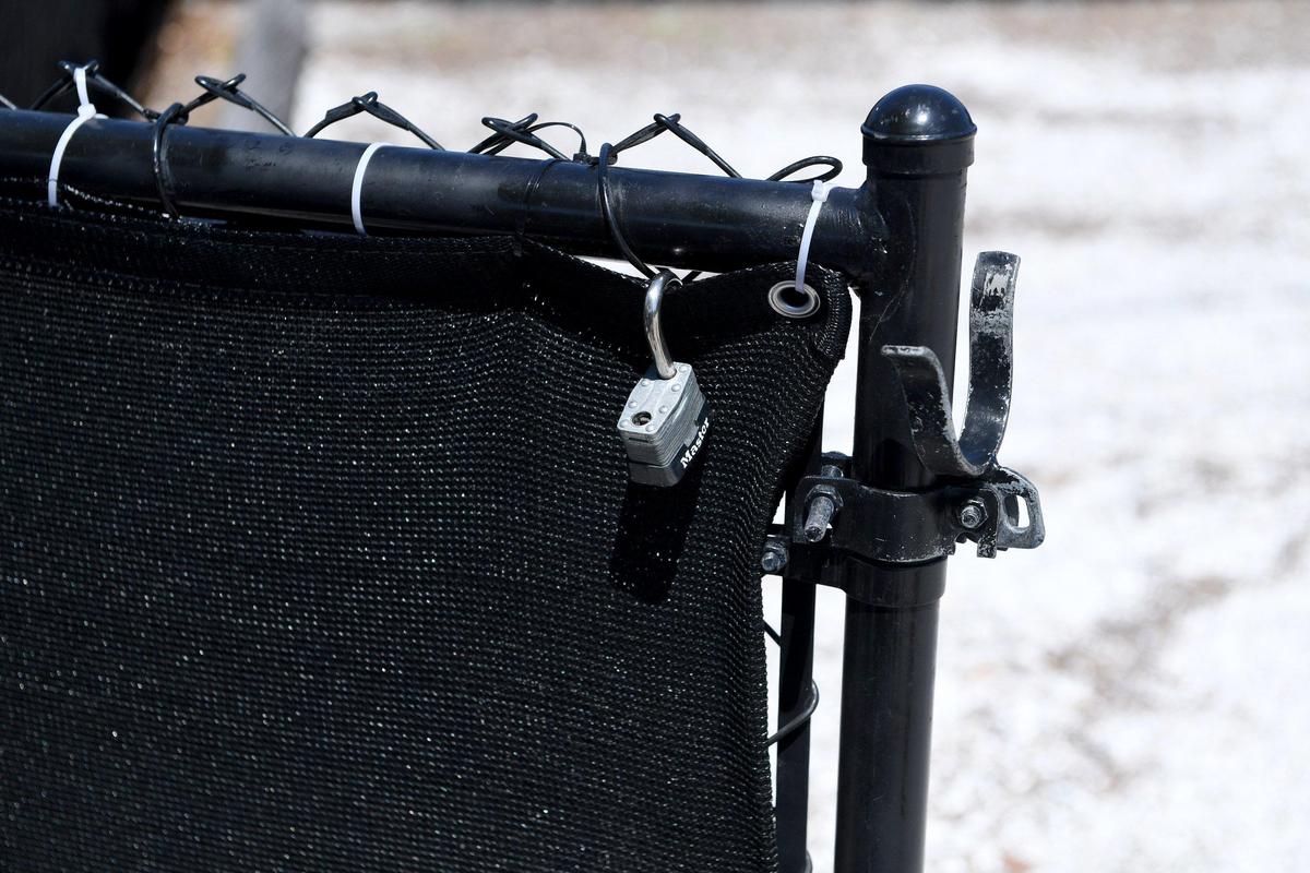 An unlocked padlock hangs on the gate to the former Tallevast Community Center, now called the Center for Success. The doors to the building were locked at 3:30 May 29, though there was a car parked in the lot.