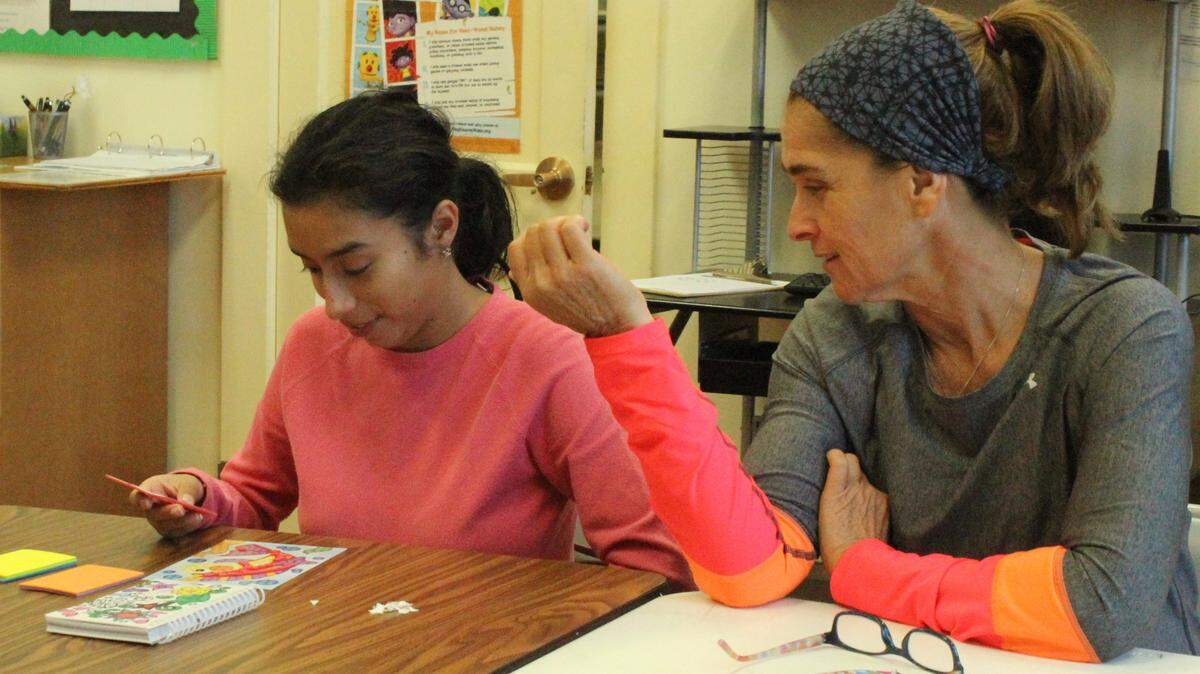Volunteer Olga Santamaria, right, works with Gina during the SOAR crafts hour. 
 JAMES A. JONES JR./Bradenton Herald