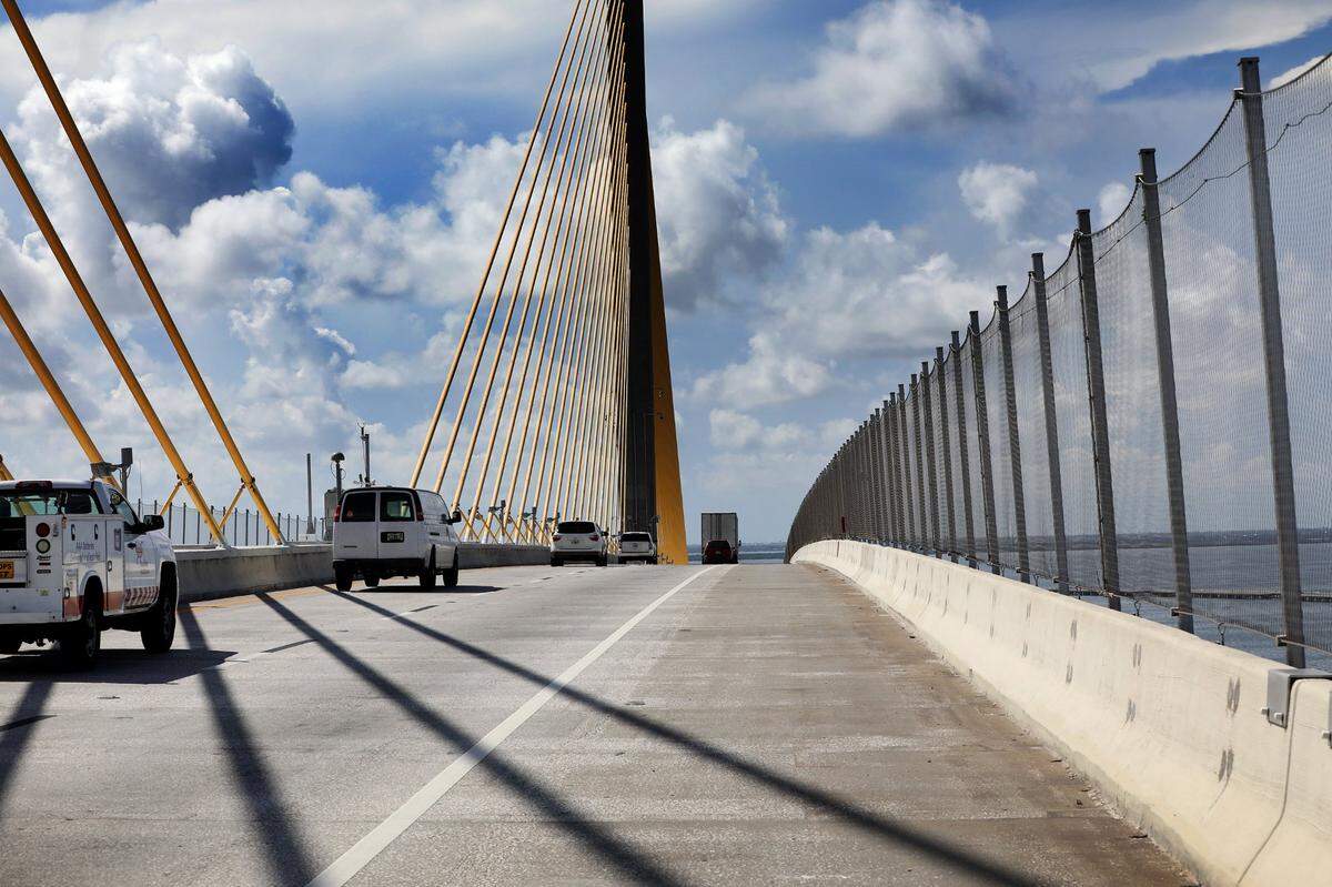 Traffic streams southbound over the Sunshine Skyway Bridge on Wednesday, July 21, 2021, in St. Petersburg, where the new suicide prevention barrier has been completed.