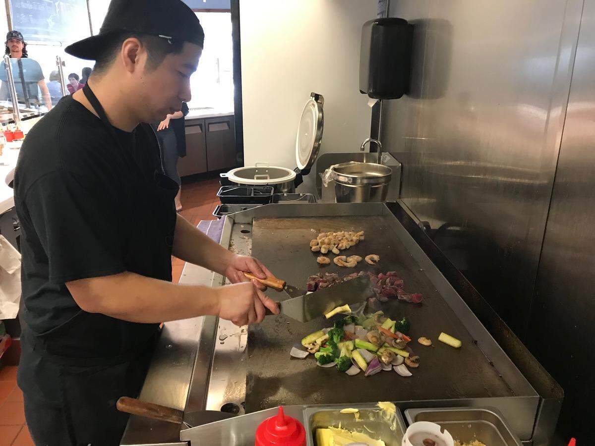 A cool prepares hibachi items at Smilefin Poke, a new restaurant at 8196 Tourist Center Drive. The restaurant is located in southern Manatee County near the intersection of Interstate 75 and University Parkway.