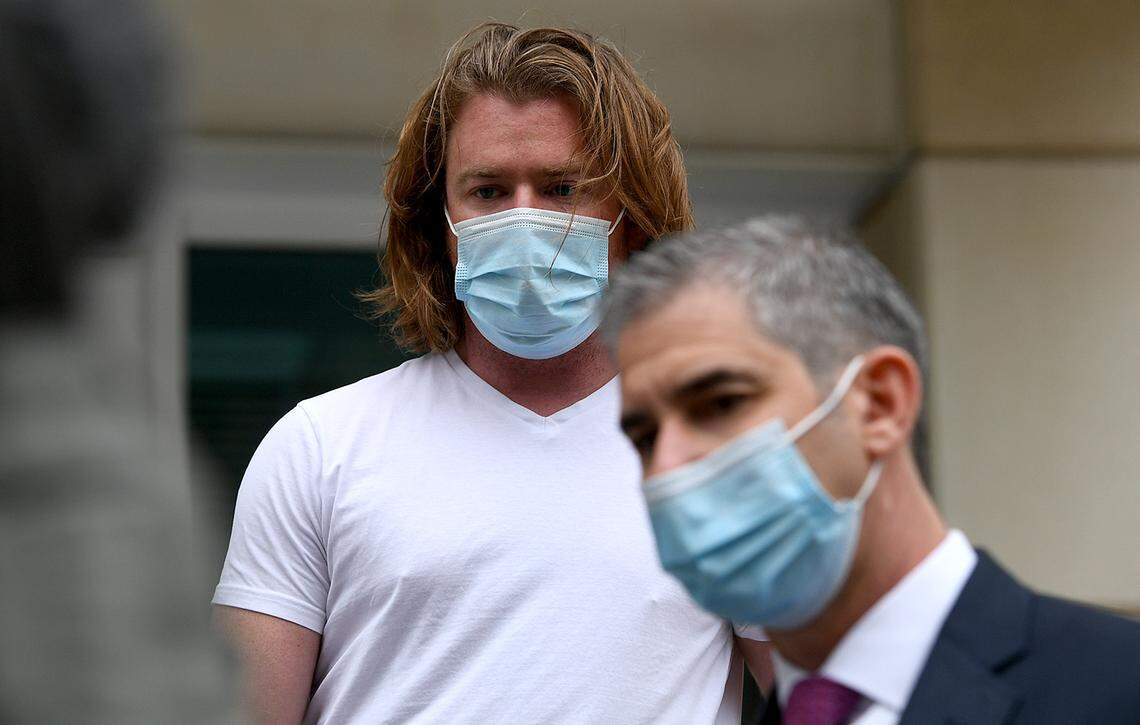Adam Johnson leaves the Tampa Federal Courthouse with attorney David Vigney after appearing in court in 2021.