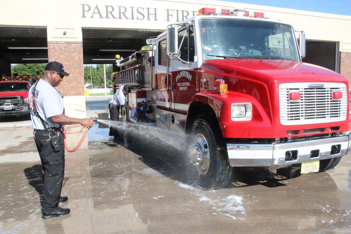 Aaron White, one of the Parrish Fire District’s  reserve responders, washes a fire truck. White, an EMT, was Manatee County’s employee of the year in 2017.