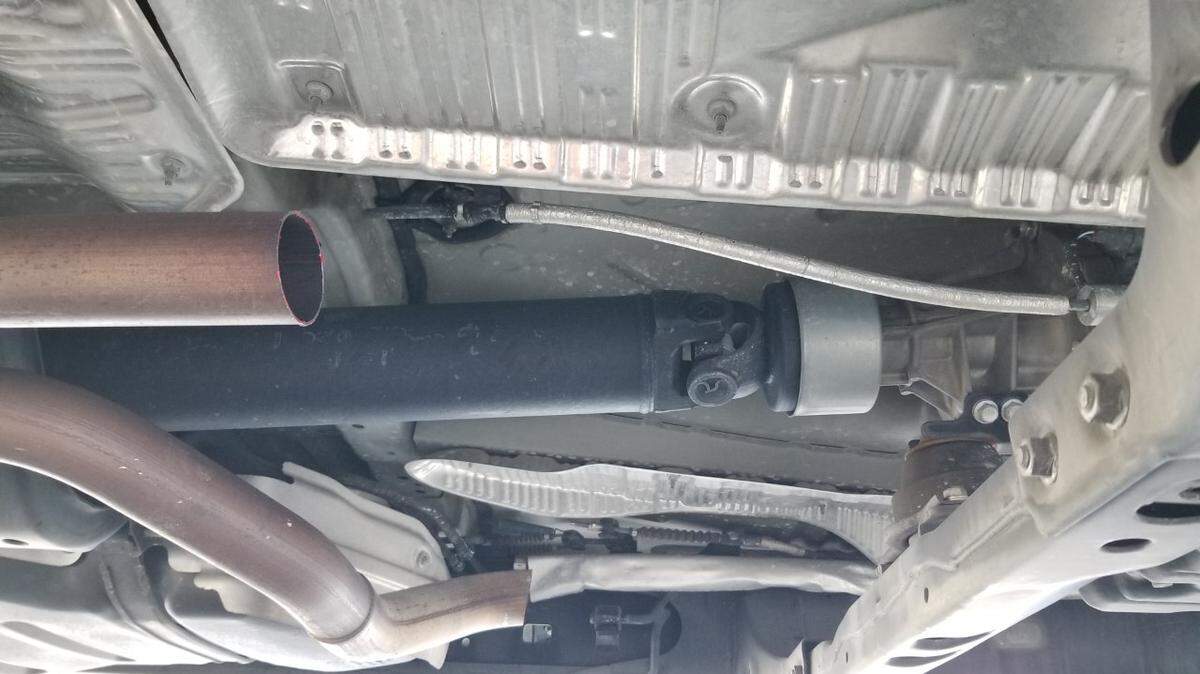 This photo was taken from underneath a Toyota truck on Tuesday, March 14, 2021, after the catalytic converter was stolen. Specks of red paint can be seen left on the remaining pipe.