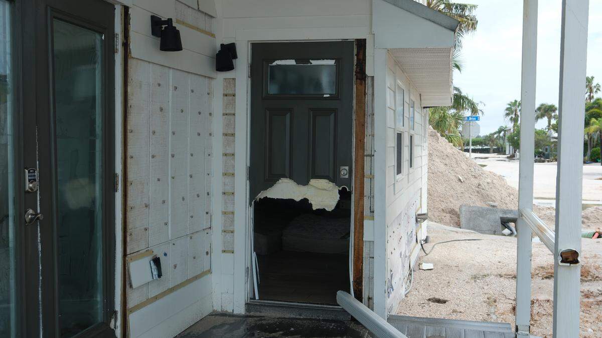 Hurricane Helene’s storm surge tore through homes on Anna Maria Island, crushing furniture, smashing windows and leaving up to 5 feet of sand along the roadway.