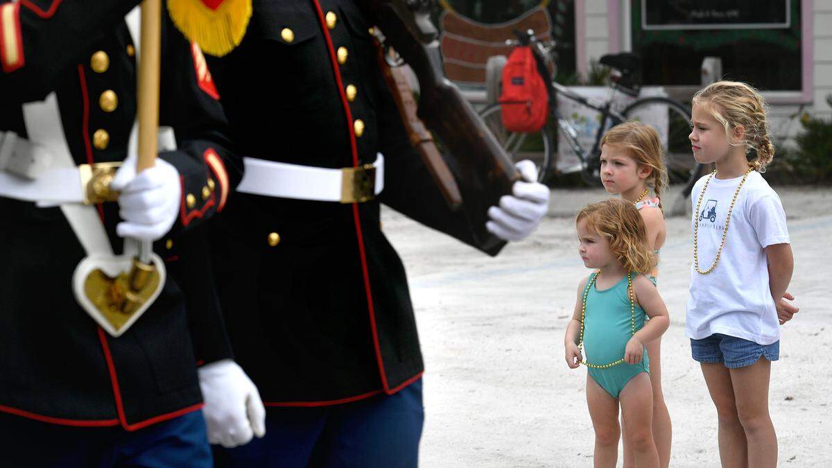 11/11/21—Young girls watch from the sidelines as Marines march in the City of Anna Maria’s Old Soldiers and Sailors Veterans Day Parade.