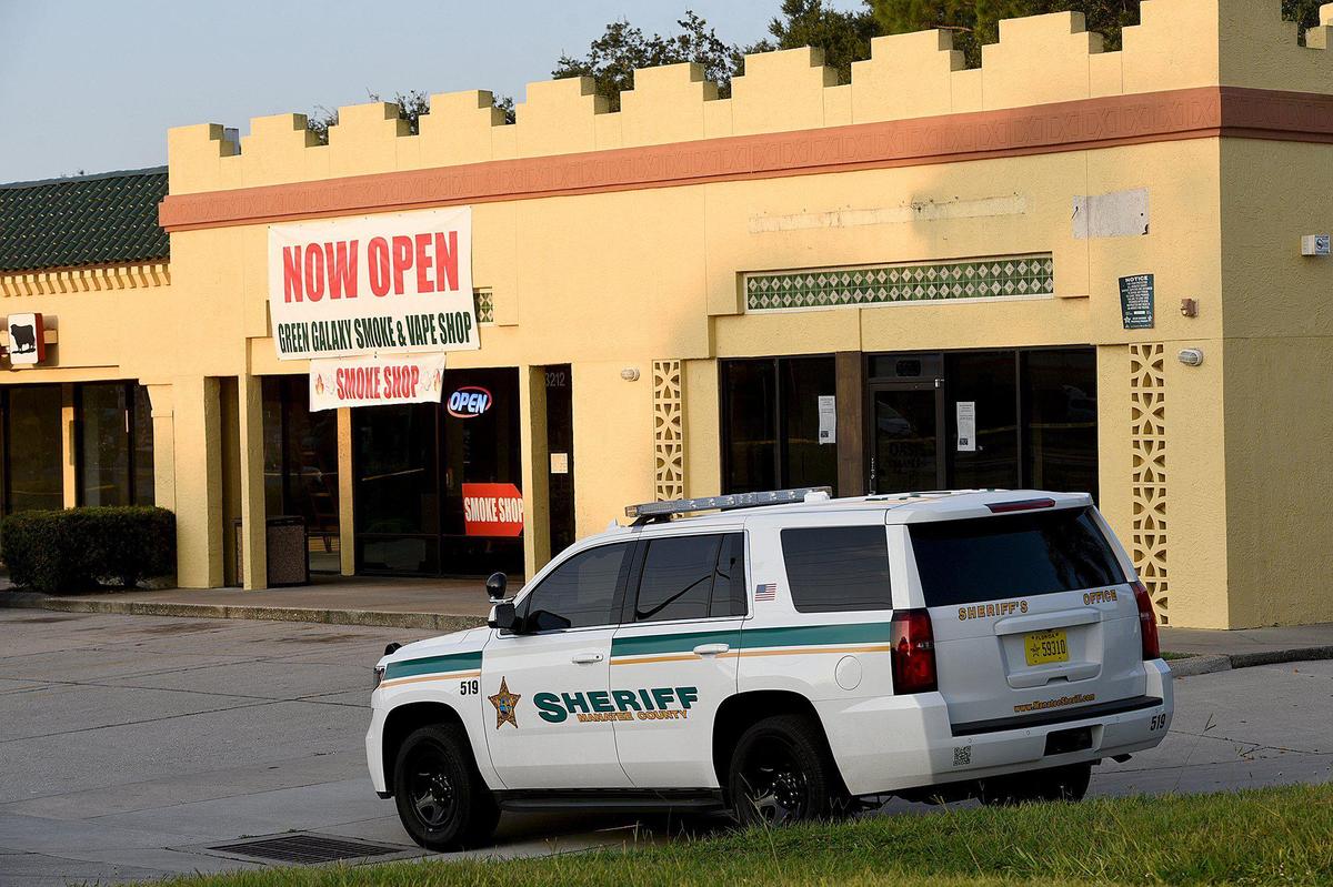 Manatee County Sheriff’s Office investigates a murder at the Green Galaxy Smoke Shop in the Oasis Plaza shopping center in Bradenton Wednesday morning.