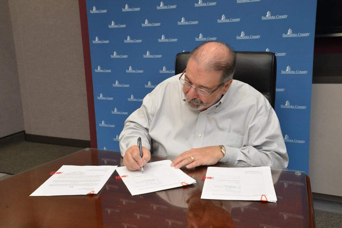 Benderson Development has bought Sarasota County’s administration building at 1660 Ringling Blvd. in downtown Sarasota for $25 million. Sarasota County Commissioner Alan Maio inks the deal.