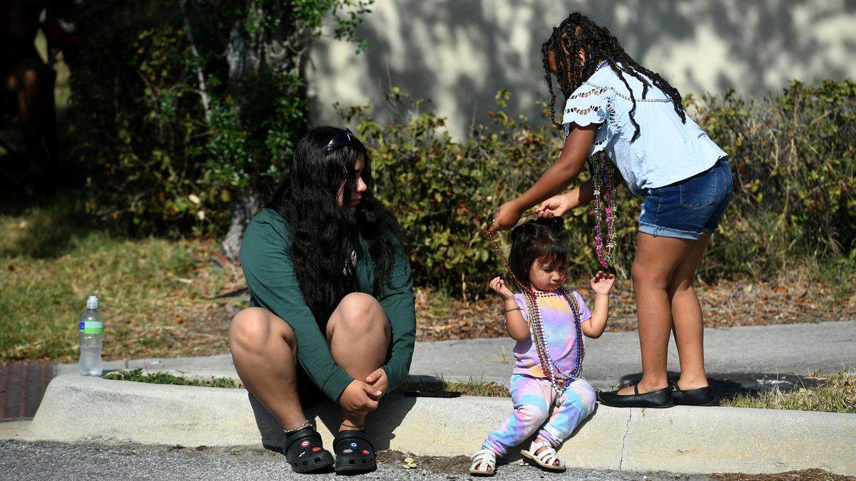A little girl shares her beads with a small child during the Hernando DeSoto Historical Society’s Children’s Parade on Friday, April 7, 2023 in Palmetto.