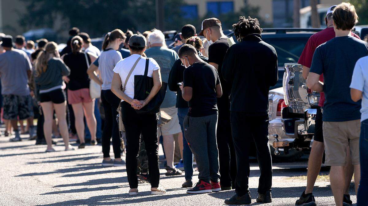 12/28/21—People form a long line at the Bradenton Area Convention Center Tuesday in Palmetto where COVID-19 testing is ongoing. There were plans to move the site to a smaller location after the New Year, but the center will continue operating until further notice.