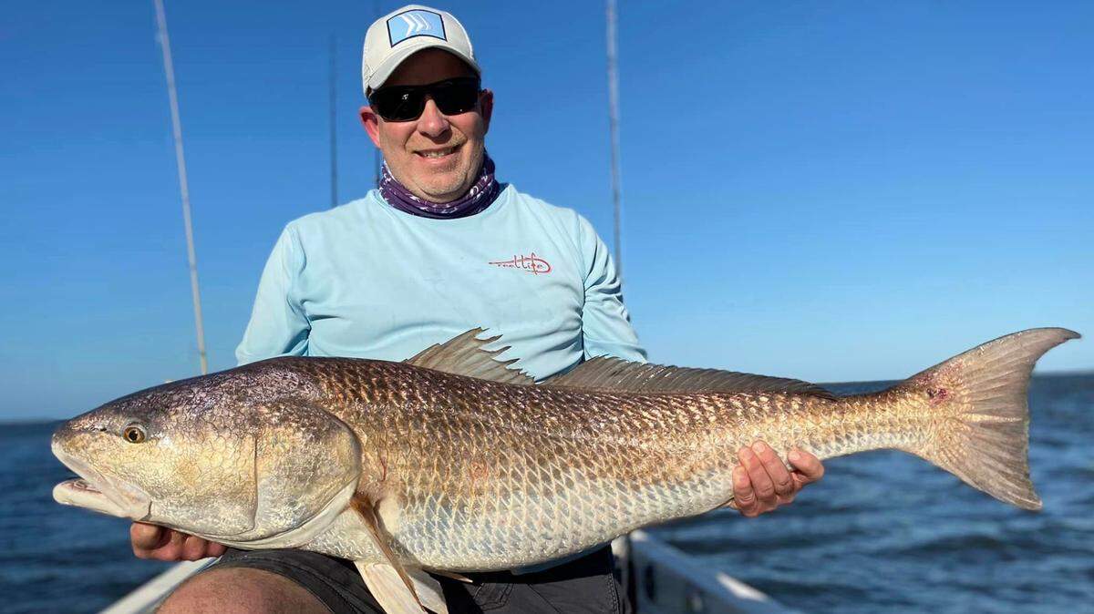 Todd Mayo with a 47 inch redfish caught fishing with Capt. Mike Goodwine