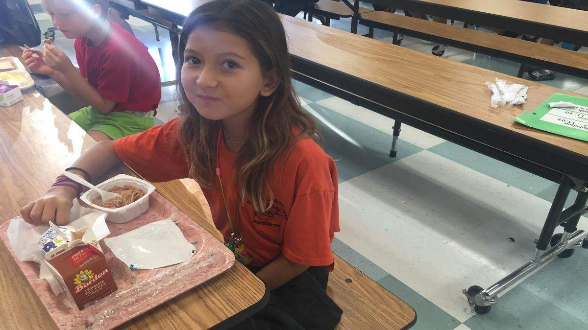 Ten-year-old Nalyse Colantuono, a fifth-grade student at Tara Elementary School, eats her breakfast concoction, Cinnamon Toast Crunch with chocolate milk. This year is the first year the school district is offering free breakfast for all students across the county. MEGHIN DELANEY / BRADENTON HERALD