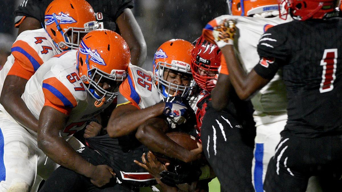 Palmetto High’s LaJohntay Wester is stopped by Southeast’s defense during the Tigers’ 54-7 win on Friday night at Harllee Stadium.