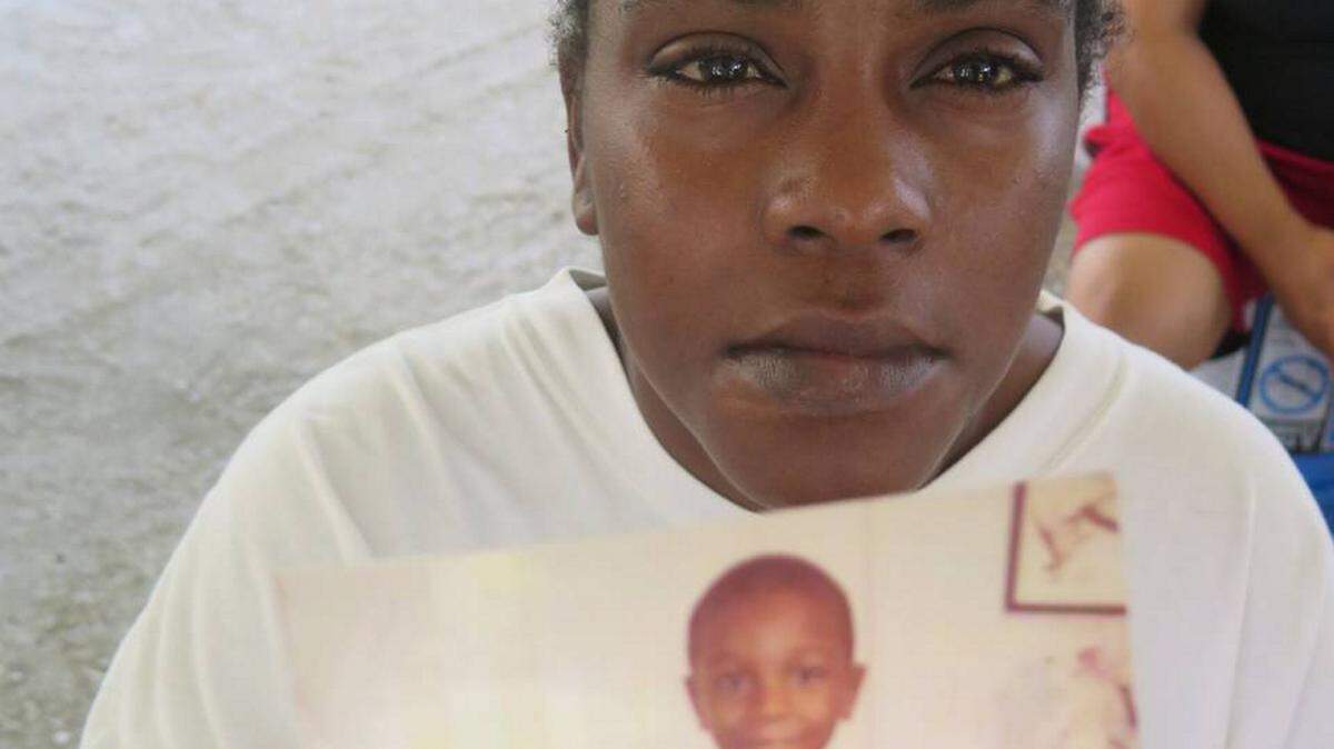 Michelle Jordan holds a picture of her son, Ginobli Yarn, 9, who died Saturday when he was hit by a car while riding his bicycle in his hometown of Rubonia. Ginobli was a rising fourth grader at Palm View Elementary School. RICHARD DYMOND/Bradenton Herald