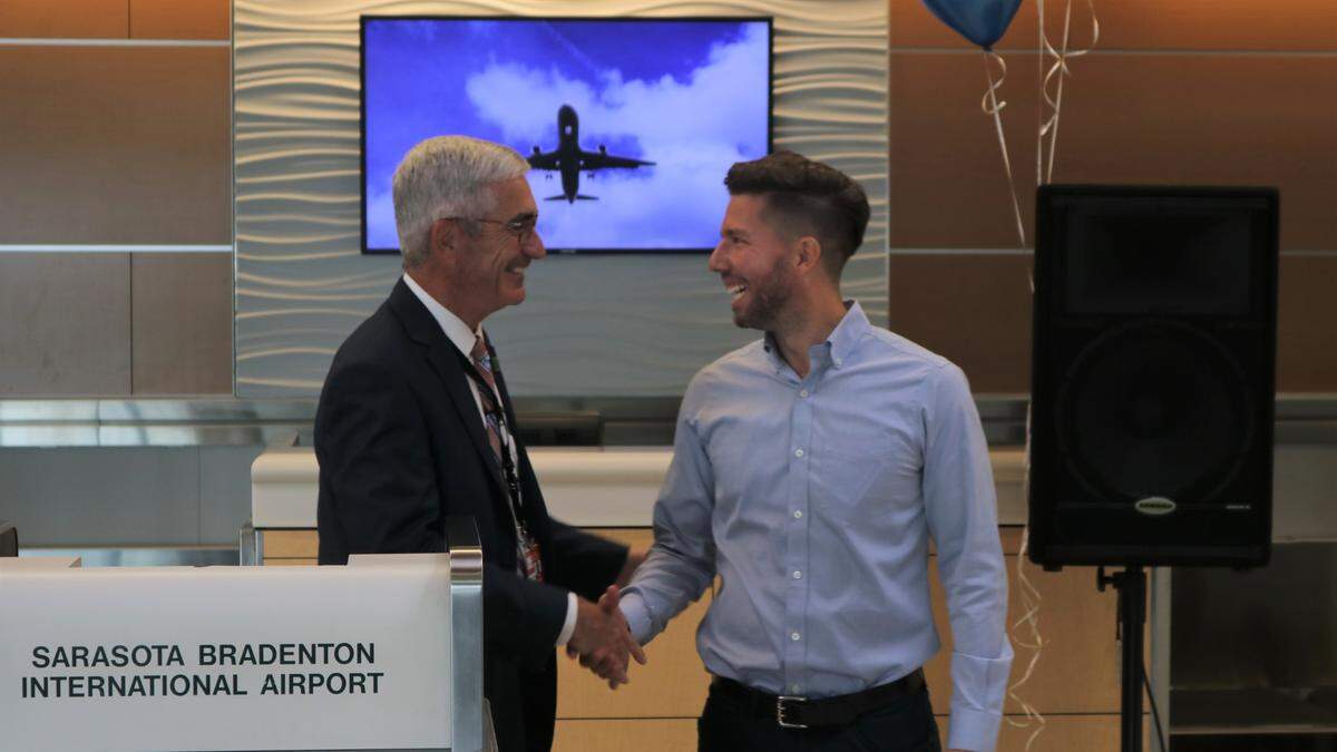 Rick Piccolo, president and CEO of Sarasota Bradenton International Airport, left, shakes Bud Hafer’s hand at the announcement of eight new Allegiant destinations from SRQ on Tuesday. Hafer is Allegiant manager of airport affairs.