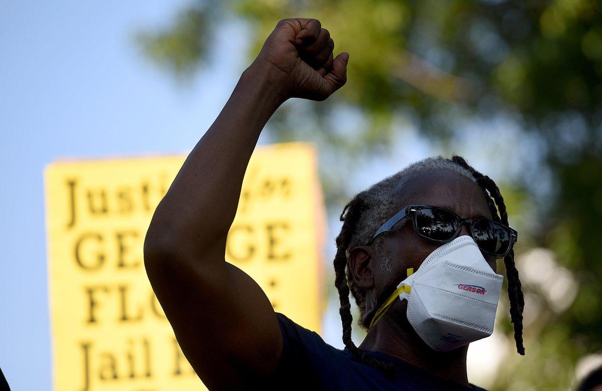 Ronald Davenport, who was charged with resisting without violence during a traffic stop on May 12, 2020, raises his hand at a protest backed by Black Lives Matter, Manasota Alliance, in Sarasota.