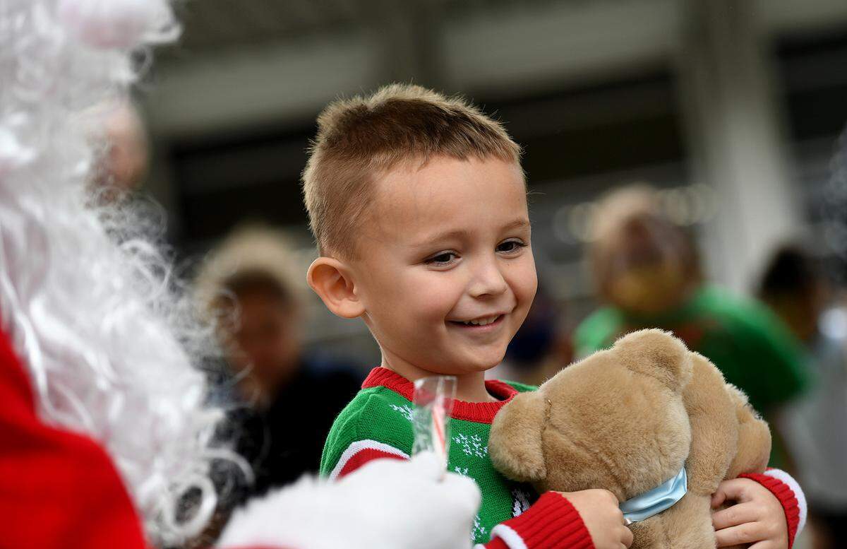 12/20/21—Jake Hartness smiles with his toy from Santa, who arrived on an East Manatee Fire Rescue truck at Bashaw Elementary School.