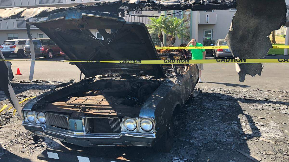 3/16/2021--Patrick Guinan looks at the charred remains of his 1970 Olds Cutlass. Guinan owned the car for 5 years and nicknamed it ‘Old Blue.’