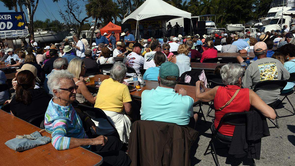 Huge crowds enjoy sunshine, seafood and music Saturday in Cortez Village during the 34th annual Cortez Commercial Fishing Festival. 
 TIFFANY TOMPKINS/Bradenton Herald